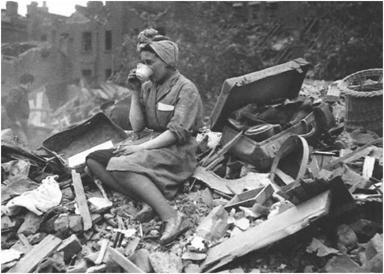 A woman drinking tea in the aftermath of a German bombing raid during the London Blitz. [1940]