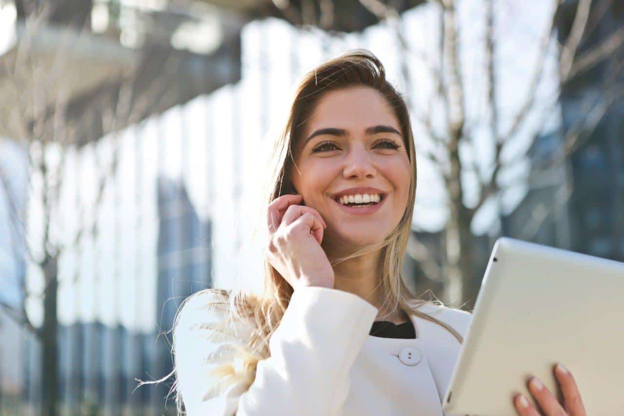 businesswoman-holding-tab-and-smiling