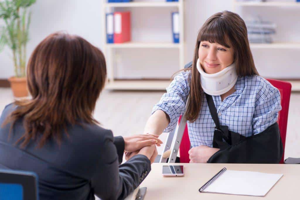 Injured employee visiting lawyer for advice on insurance attorney lawyer