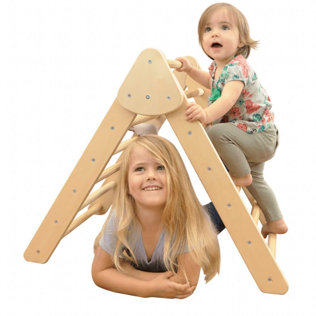 Kids playing on pikler