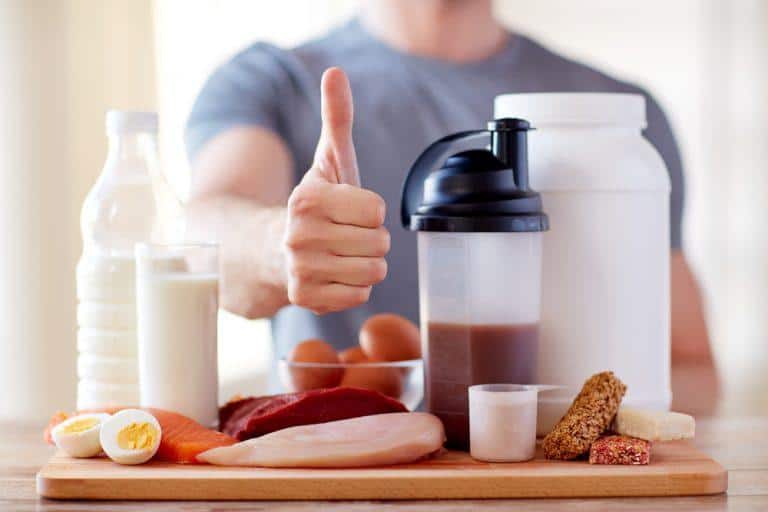 man with protein food showing thumbs up
