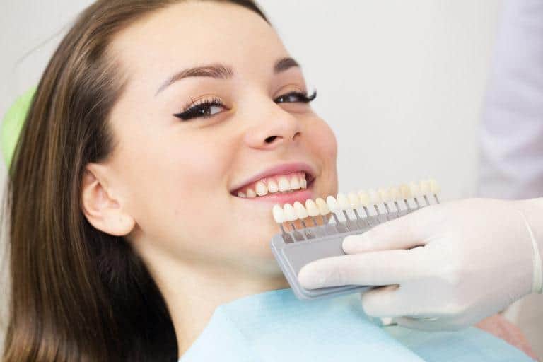 teeth whitening by a dentist,Close,Up,Portrait,Of,Young,Women,In,Dentist,Chair,,Check